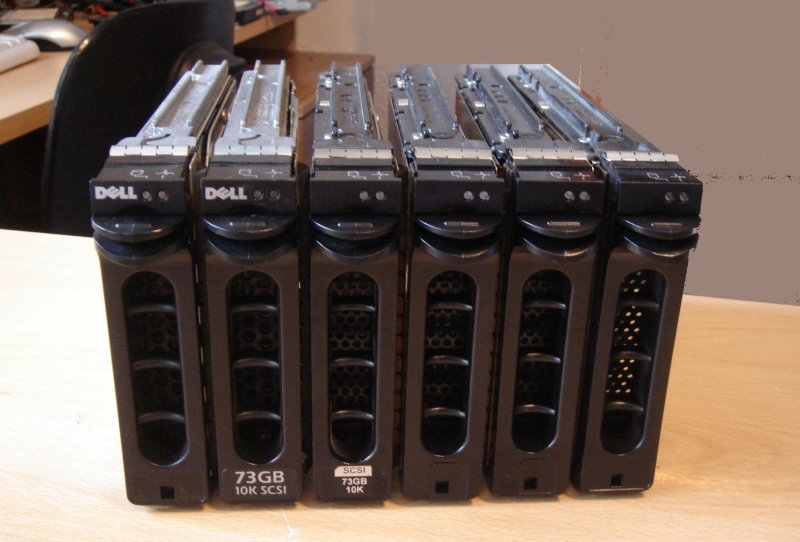 A stack of SCSI hard drives taken from a Ubuntu Linux Server. There are 6 scsi 3.5inch disks in this picture of the array which had failed after power failure and one drive showed as ASYN start unit request failed.
