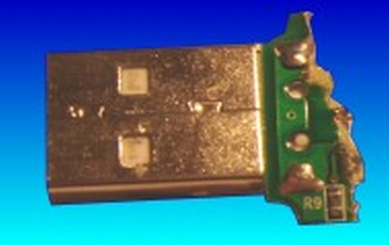 The broken end of a USB circuit board. The pcb has cracked just behind where the metel usb connector is soldered to the plastic. We have repaired such devices in order to recover the data. USB dongle often requires simialr re-solder repairs. 