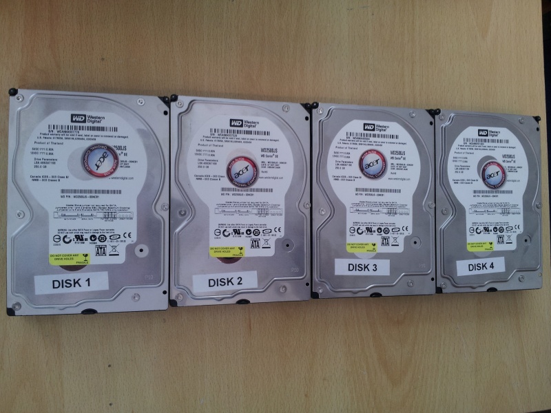 4 off 250gb SATA hard disks taken from an Acer Altos Easystore NAS that no longer had LAN network access. The disks were labelled 1 to 4 and made by Western Digital model Caviar SE WD2500JS. The disks are shwon lined up side by side.
