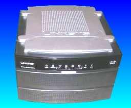 This photo was taken from the top of the Linksys NAS200. The unit has a silver top and dark grey base with status leds on the front. It shows positions for 2 hard drives.