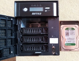 A Terastation Pro TS-HTGL-/R5 shown with it's drive bay door opened and the Western Digital SATA drive extracted, leaving the 3 other raid drives in place. This NAS first suffered a disk failure throwing up an E13 Raid Array error, followed by an E14 error when attempting a rebuild after replacing the faulty disk.